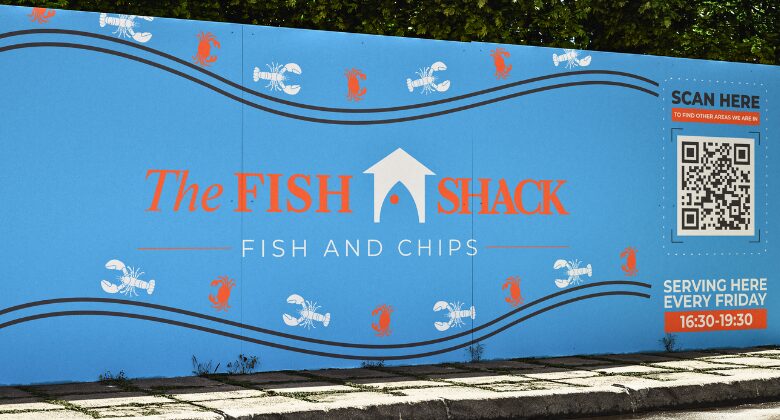 Printed site hoarding around a fish and chip shop fit-out